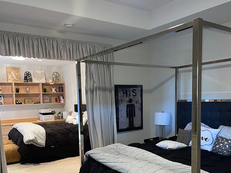 Main bedroom with King and queen beds. There are 3 additional beds stored in walk-in closet.