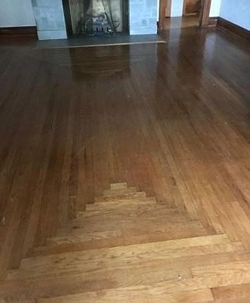 Floor in front of fireplace in den