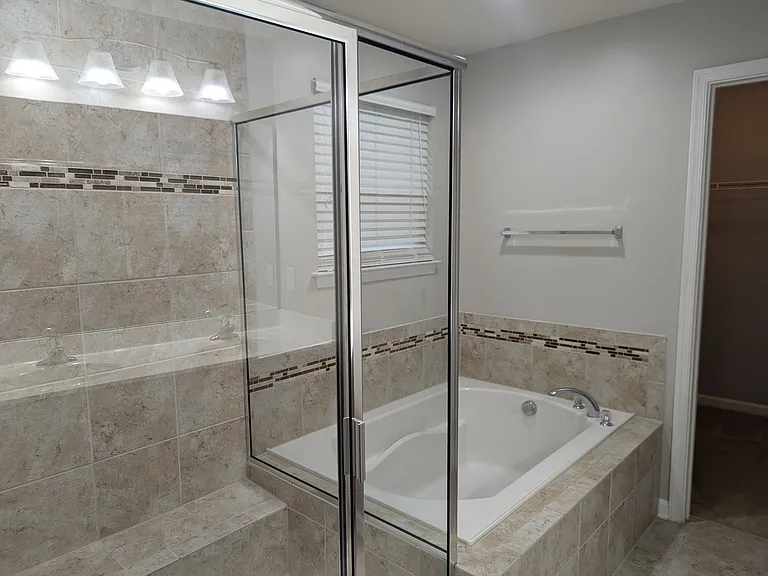 large tub and separate shower in the primary bathroom
