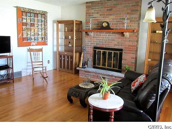 Great Room. The Great Room features a raised-hearth fireplace, gleaming original hardwoods, and a neutral dcor.