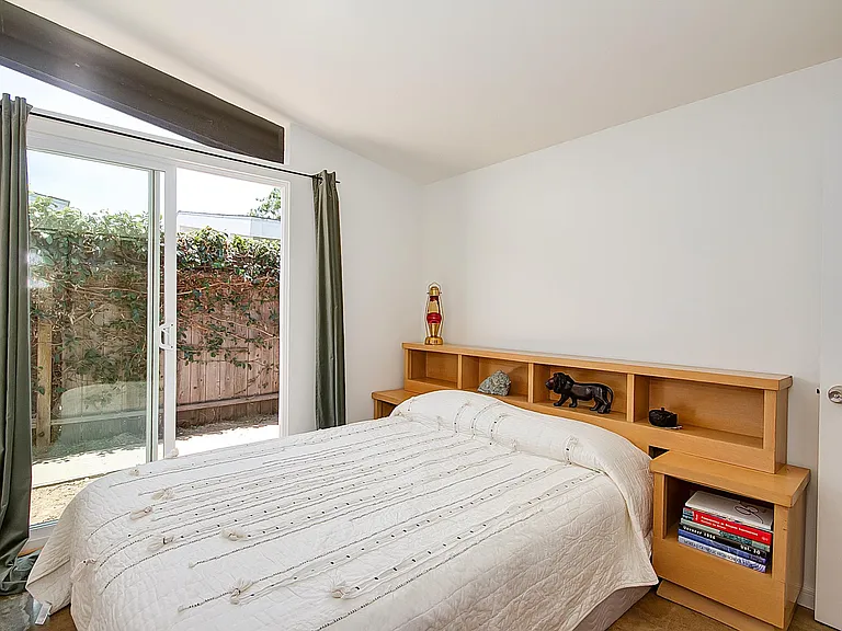 Bedroom 3, sliding door access to side yard.