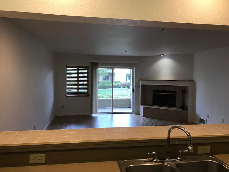 Kitchen, looking over bar into living room.