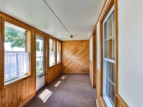 Beautiful corner lot with in ground sprinkler, mature trees and perennials.  Paver walkway leads to the open front porch.