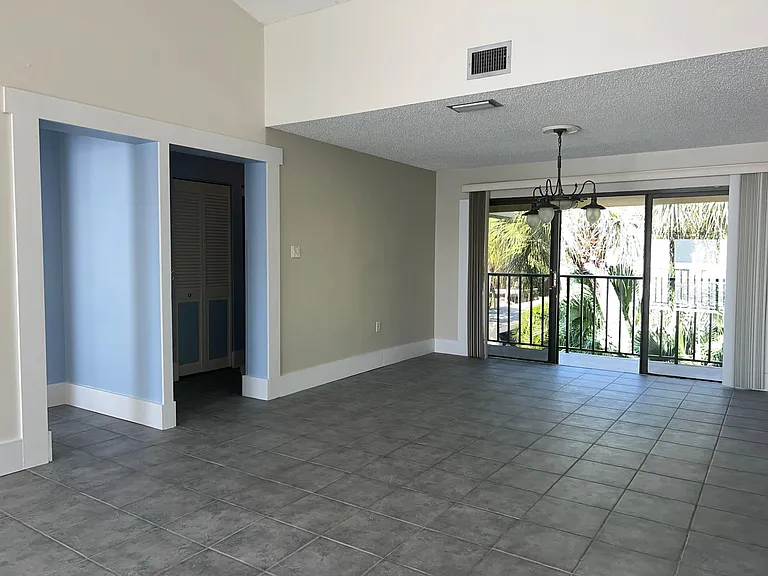 Dining room with sliding door opening to 2nd balcony overlooking pond (facing west)
