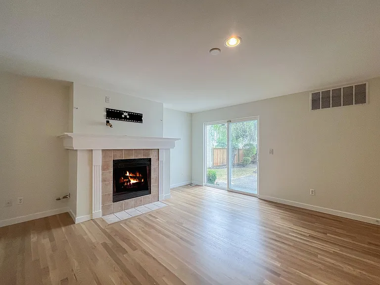 Living Room with Fireplace. Door opens to backyard