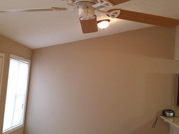 Ceiling fan and vaulted ceiling in tiled family room