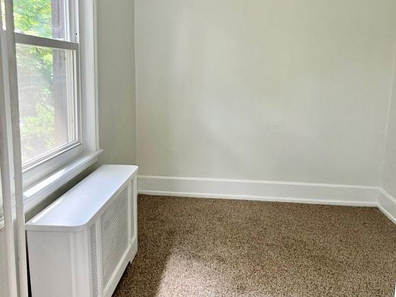 Bedroom one. Remote operated fan has been installed. High ceilings and large window.