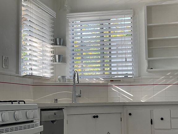 Kitchen corner sink with Bosch dishwasher. Gas stove and oven.