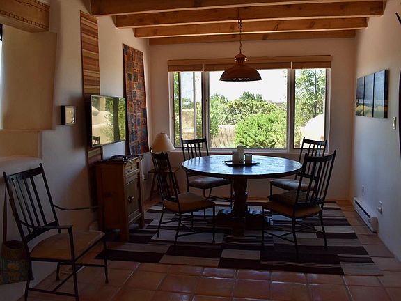 rustic round table in kitchen, overlooking walled garden