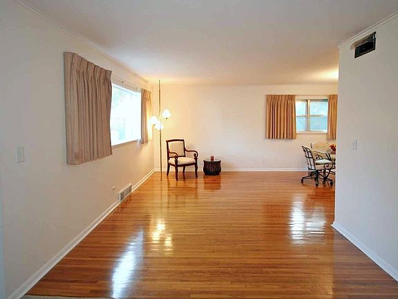 View of living room from adjacent entryway. Gorgeous hardwoods! 