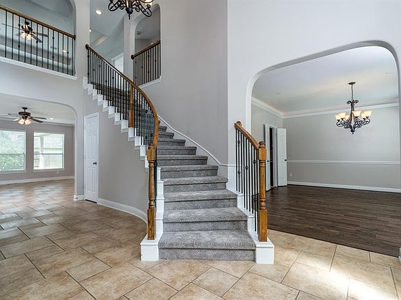 Large open floor plan with recent flooring upgrades including this subtle patterned carpeted staircase.