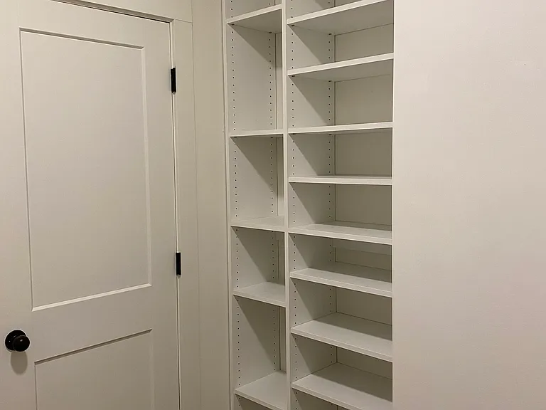 Addition storage in master closet which can hold 36 pairs of shoes designed by Closet Pro.
