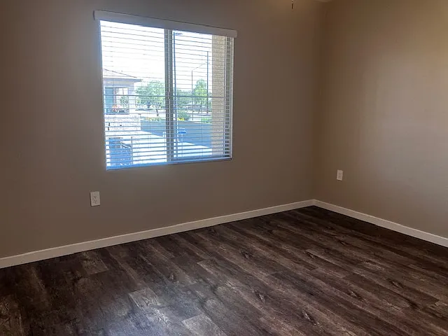 Good sized master bedroom with ceiling fan and large window.