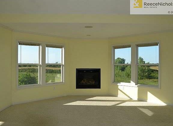 Master Suite offers Sitting Area with Scenic View, Fireplace and Vaulted Ceiling with Fan (not shown in photo)