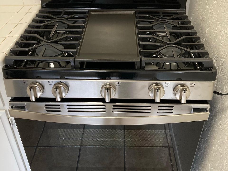 Brand new stainless steel 5-burner stove (with a central grill) and oven