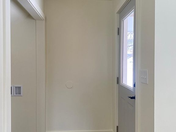 Front door entry with closet, leads into living space