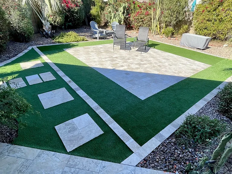Enjoy this BRAND NEW upgraded backyard to include travertine/turf expansive relaxing area plus wine/propane firepit table & lucscious Arizona palms, flowers and trees surround you!