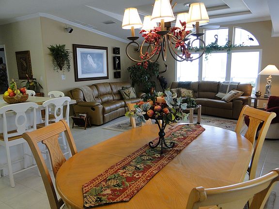 Dining area, living, and kitchen connect in bright open floor plan