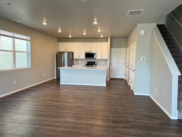 Ground floor with kitchen island, door to the garage, and a half bathroom