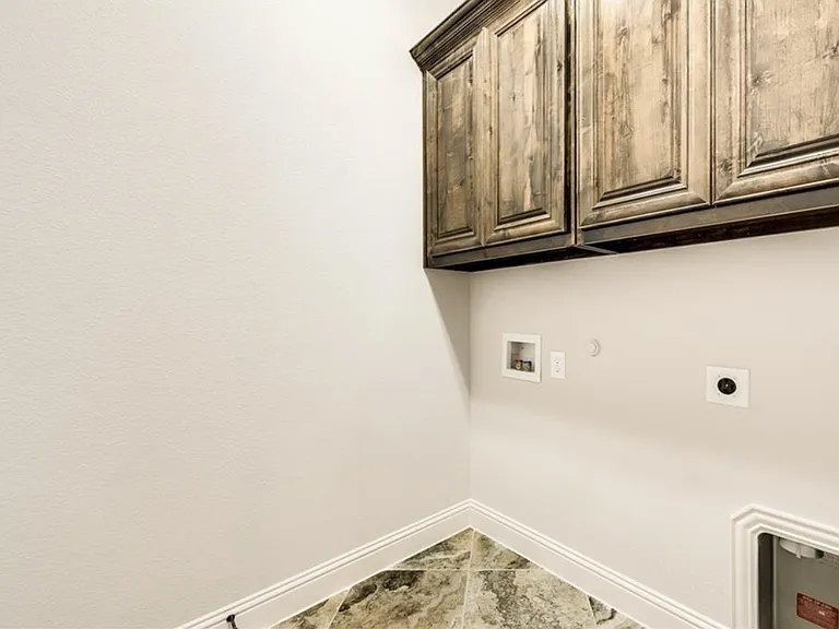 Utility room with upper cabinets