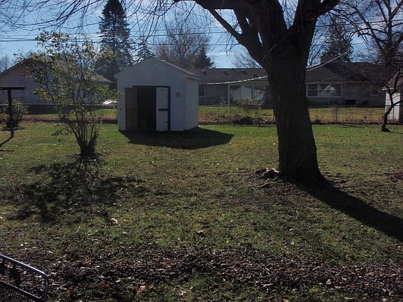 Fenced backyard with storage