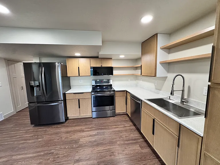 Modern kitchen with sleek cabinetry, open shelving, stainless steel appliances, and ample counter space_designed for both style and functionality.