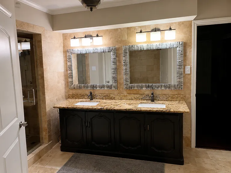 Primary bath - granite sinks, shower to the right
