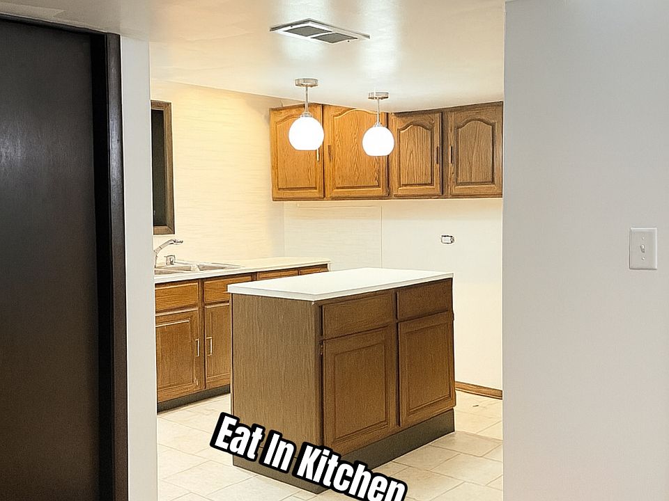 Kitchen with newly installed back splash and island. Appliances included