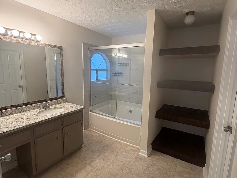 Primary bathroom with extra storage/linen shelves
