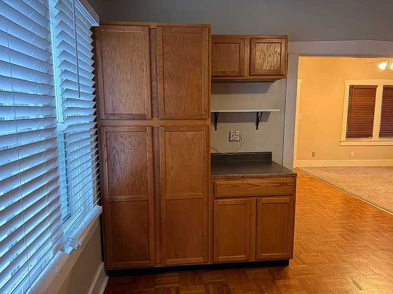 Kitchen pantry next to doorway leading to living room