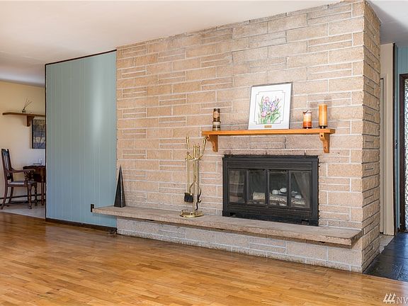Another view of the wood burning fireplace with both mantle and hearth.  Main floor has natural gas heat.
