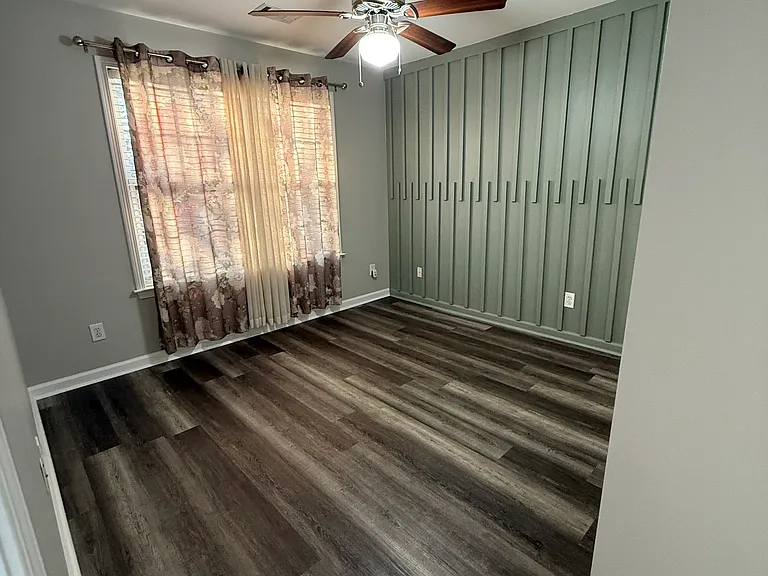 Bedroom Facing Street with Accent Wall and Plenty of Sunlight