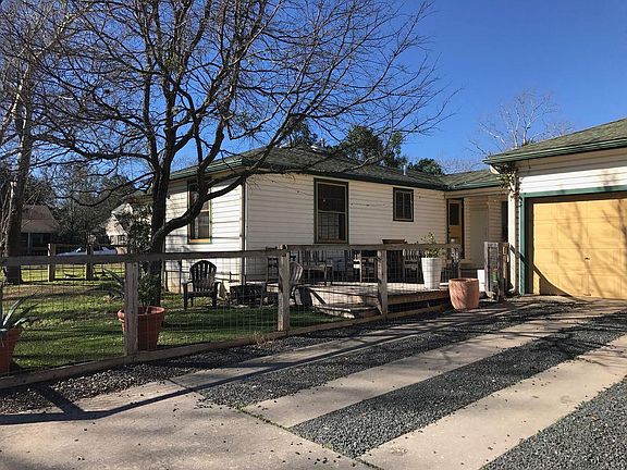 2 car driveway next to the porch and and fenced in back and 