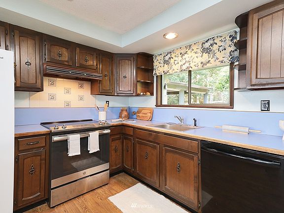 Kitchen with newer appliances and retro cabinets
