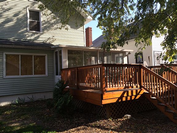 Back of home showing deck off of Sun room