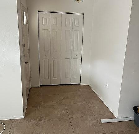 Beautiful entryway with coat closet and lighting