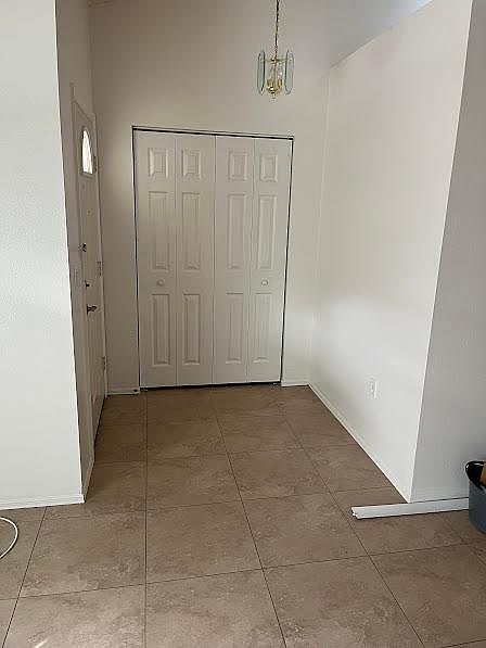 Beautiful entryway with coat closet and lighting
