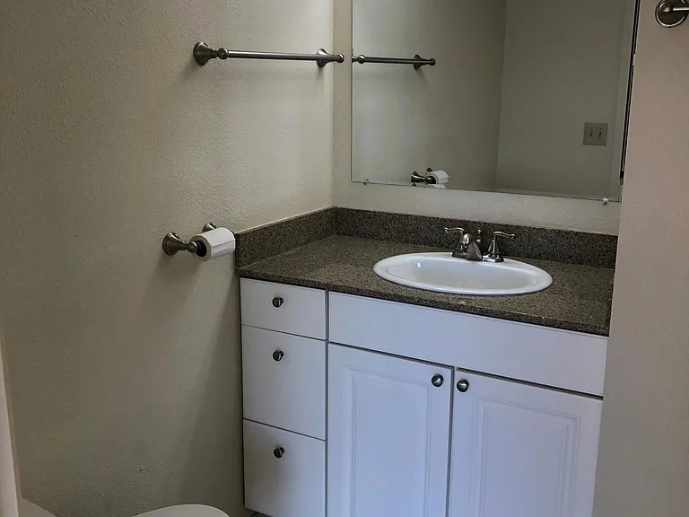EN-SUITE BATH | HOLLYWOOD LIGHTING | COMFORT HEIGHT VANITY WITH ABUNDANT STORAGE AND COMFORT HEIGHT TOILET | EZ CLEAN TILE FLOORING