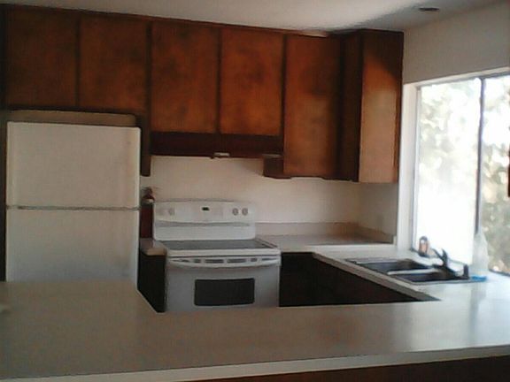 newer appliances, wrap around counter, bar seating
