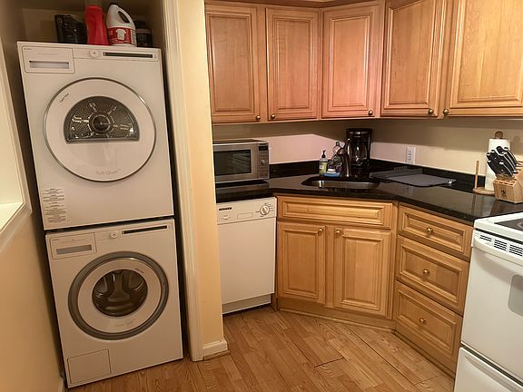 Kitchen close-up including washer/dryer, dishwasher, microwave and coffee maker