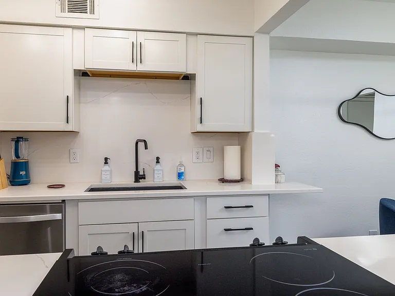 Cook with ease in this modern kitchen featuring stainless steel appliances, sleek countertops, and stylish cabinetry. Fully equipped for meals and late-night snacks.