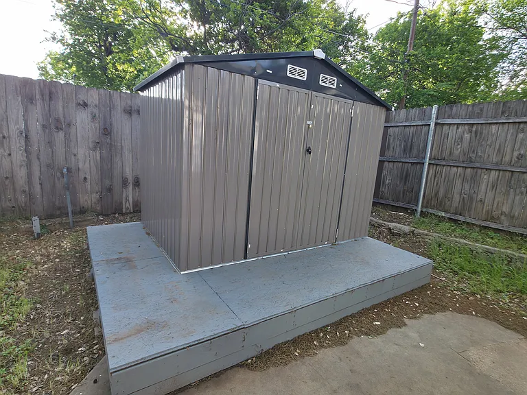 Storage shed included with mower and edger inside