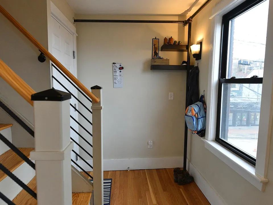 entryway and stairs to upstairs bedrooms/full bath