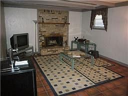 Den located on lower level w/remodeled bath done in tile & granite. Fireplace