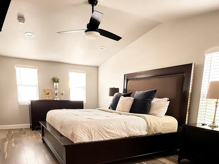 Large Master bedroom with king bed, 43" Smart TV, large 6-drawer dresser, and dual night stands