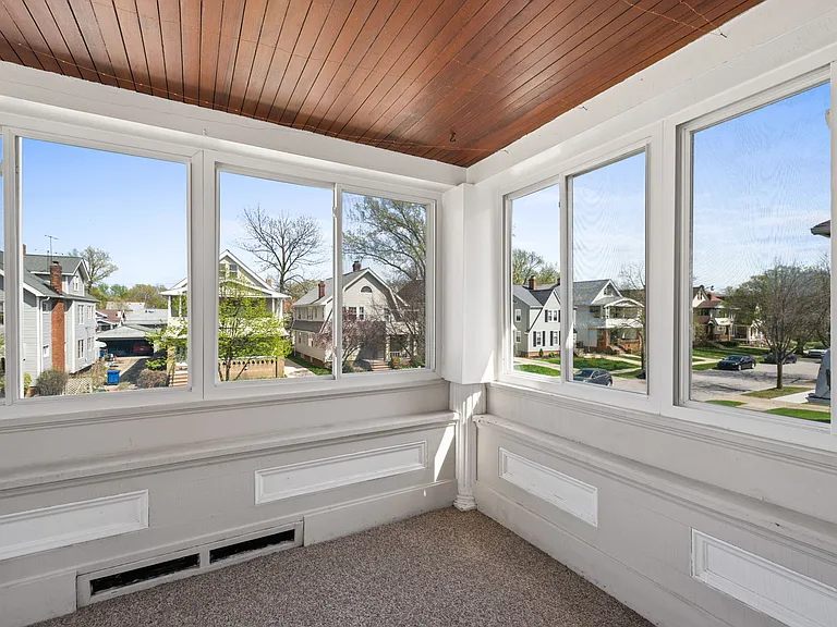 This is the sunroom located on the second floor/main floor of the unit, connected to the living room.