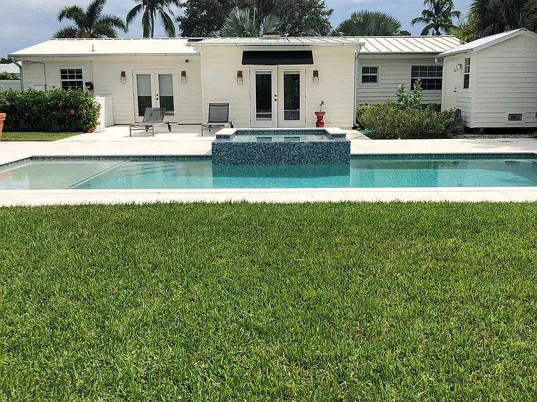 Yard with swimming pool and spa.