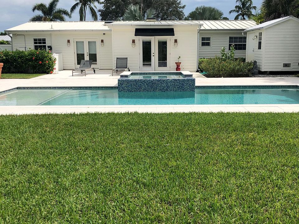 Yard with swimming pool and spa.