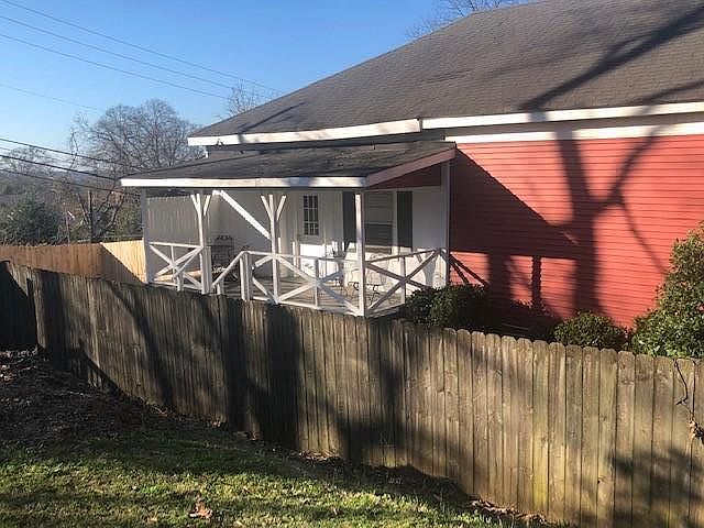 Condo entrance with private fenced-in yard.