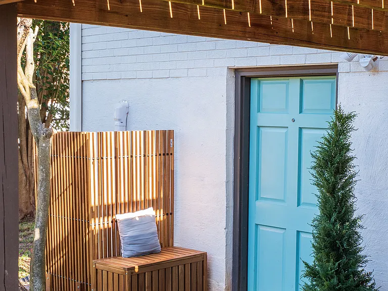 Separate private entrance with outdoor entryway bench.
